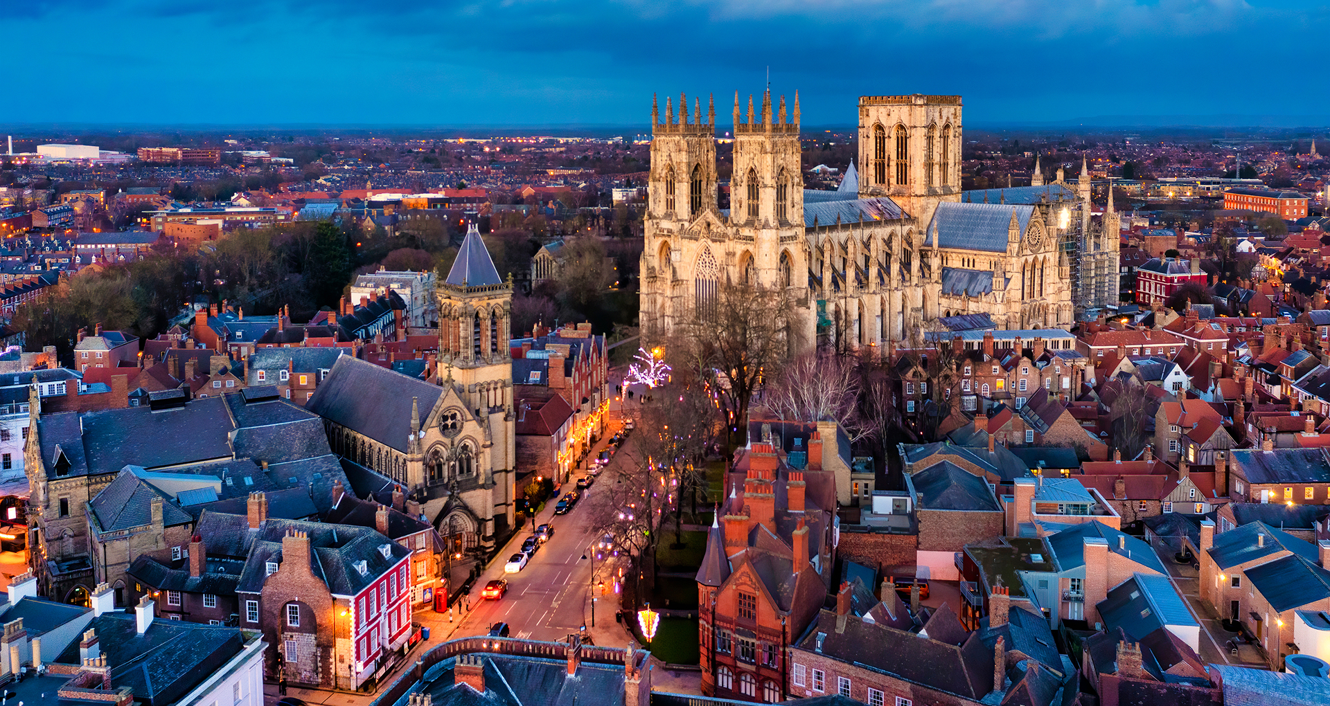Las calles medievales de York cobran vida con luces navideñas centelleantes y el brillo navideño en una noche de invierno.