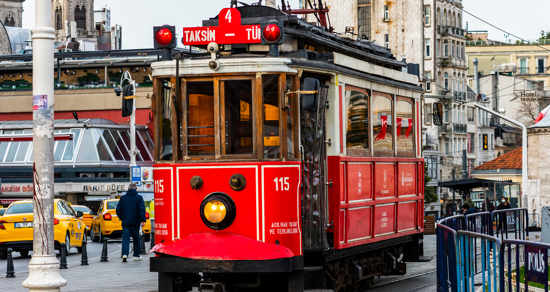 El icónico tranvía rojo de la Plaza Taksim, puerta de entrada a la vibrante Calle Istiklal en Estambul. El icónico tranvía rojo de la Plaza Taksim, puerta de entrada a la vibrante Calle Istiklal en Estambul.